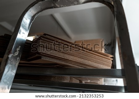 stacks of containerboard sheets in warehouse facility