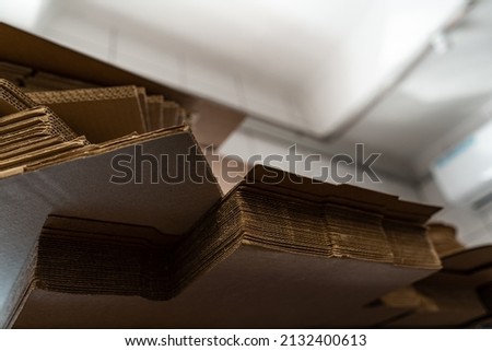 stacks of containerboard sheets in warehouse facility
