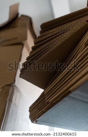 stacks of containerboard sheets in warehouse facility