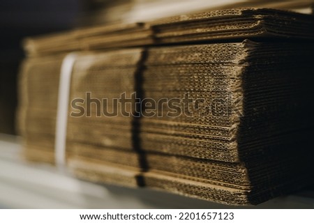 stacks of containerboard sheets in warehouse facility
