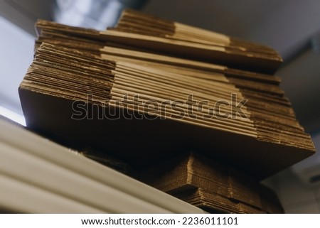 stacks of containerboard sheets in warehouse facility