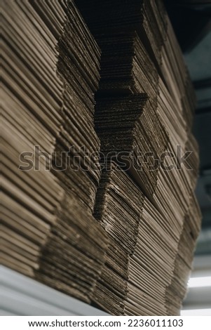 stacks of containerboard sheets in warehouse facility