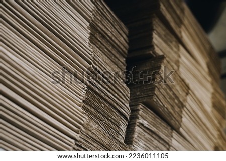 stacks of containerboard sheets in warehouse facility