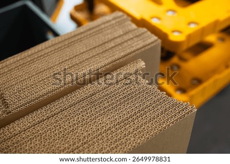 stacks of containerboard sheets in warehouse facility