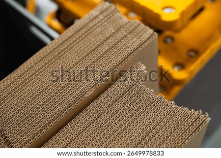 stacks of containerboard sheets in warehouse facility