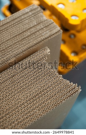 stacks of containerboard sheets in warehouse facility