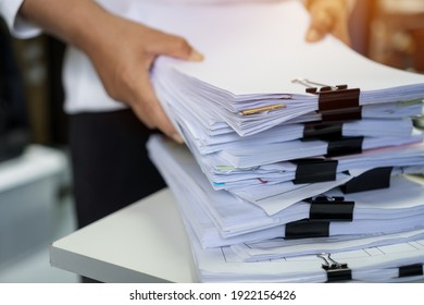 Stacks of lot documents report papers with clips waiting be managed by office workers arranging on desk in busy office. Concept of workload in business finacial paperwork information or investigate