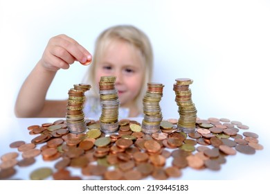 Stacks Of Euro Currency Coins, Small Child, Blonde Girl 3 Years Old Playing With Cash, Pocket Money Against White Background, Concept Of Financial Literacy Of Children, Inflation, Personal Savings