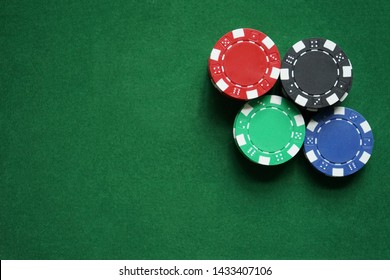 Stacks of gambling/poker chips on green background, casino concept