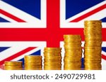 Stacks of gold coins in front of Great Britain flag. Financial development of Great Britain