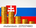 Stacks of gold coins from highest to lowest with flag of Slovakia on the background. Concept of economic decrease, fall, crash. Negative financial rate in Slovakia