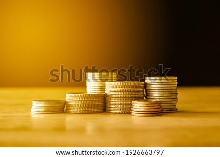 stacks of gold money coin on black background, Business and Saving money concept. 