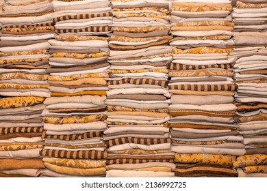 Stacks Of Linen Fabric Stacked. Factory For Tailoring Textiles. Warehouse Clothes As A Background.