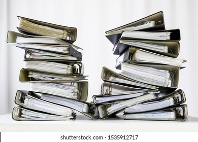 Stacks Of Many Ring Binder With Files, Folders And Documents On An Office Desk, Concept For Too Much Work And Burn Out In The Business, Selected Focus