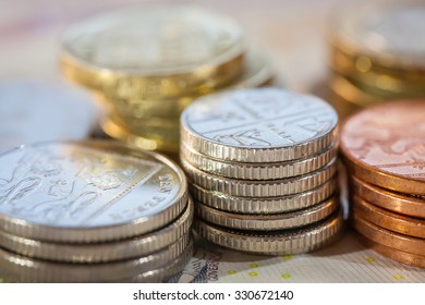 Stacks of money, UK coins of one, five, ten and twenty pence and pound coins
