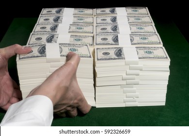 Stacks Of One Million US Dollars In Hundred Dollar Banknotes On Green Table.