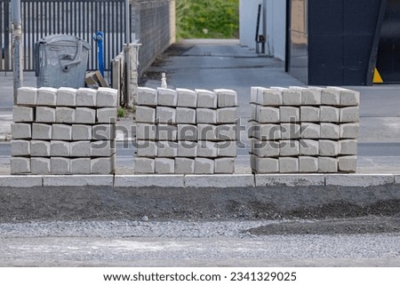 Stacks of Path Kerb Edging Stones Blocks at Street Construction Site