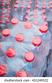 Stacks Of Red Capped Water Bottles Ready To Be Distributed As A Part Of  A Disaster Relief Effort.