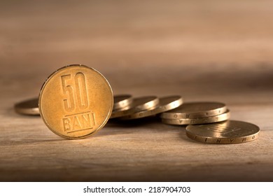 Stacks Of Romanian Fifty Bani Coins On Wooden Table, With Selective Focus