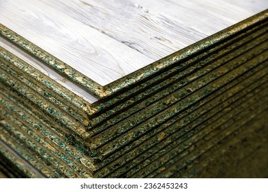 stacks of tongue and groove water resistant OSB compressed sawdust sheets. - Shutterstock ID 2362453243