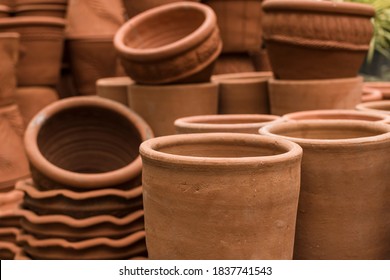 Stacks of various terracotta pots for plants for sale at a garden store.