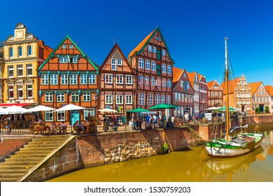 Stade - July 2019, Germany: Cityscape Of A Small, Beautiful German Town With The Traditional Half-timbered Architecture And Canal With An Old Wooden Sailboat