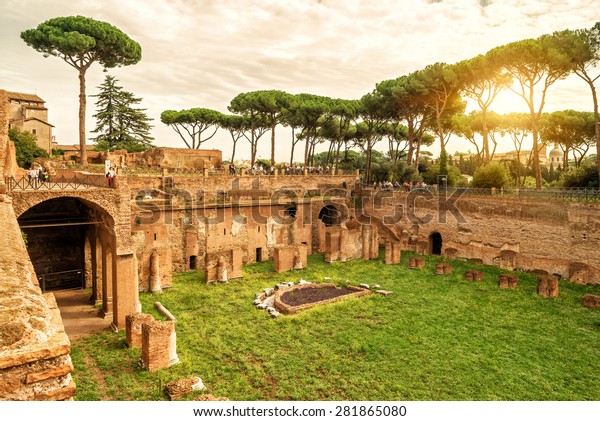 Stadium of Domitian on Palatine Hill, Rome, Italy.\
It is landmark of Rome. Landscape of Ancient Roman ruins and pine\
trees on Palatine, sunny view of old Roma city. Sightseeing and\
Palatine theme.