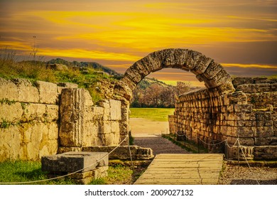 Stadium entrance  - Stone walls and arch entering the field where first  Pah Hellenic games  took place in Olympia Greece at sunset.