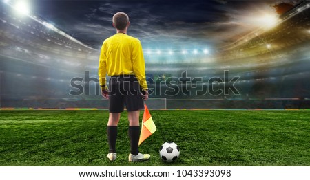 Stadium in the evening in full light before the match. Referee on the field before the match