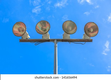 Stadium Flood Lights At Basketball Field Against Blues Sky And White Cloud