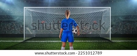  Stadium and goal post and a female soccer player in front of the soccer goal.