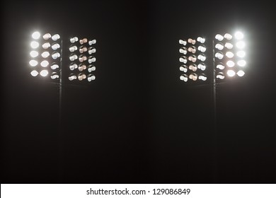 Stadium lights against dark night sky backgroundon