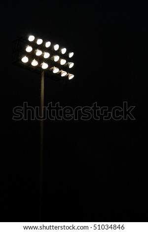 Stadium lights on a sports field at night with copy space