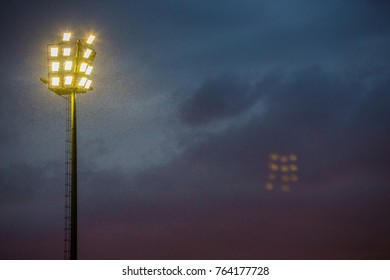 Stadium Lights on a stormy evening. Flood lights on a cloudy afternoon. Lighting the way - Powered by Shutterstock