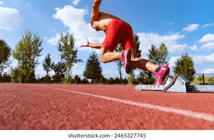 Stadium, man running and start block of athlete on a runner and arena track for sprint - Powered by Shutterstock