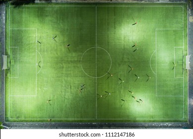 Stadium At Night. Night Football Match. Two Teams Play Football Under The Spotlights. Night Workout. Preparation For The Match.  Aerial Shot With A Drone From A Altitude