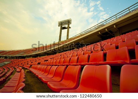 stadium, red seats on stadium steps bleacher with spot light pole