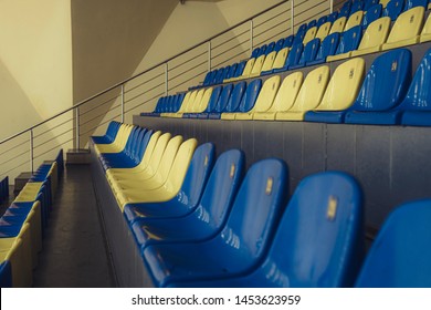 Stadium Seats. Sport Arena Blue And Yellow Plastic Seats. Indoor