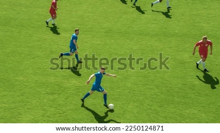 Stadium Soccer Football Match International Championship. Blue Team Attacks, Plays in Pass, Dribbling. World Tournament. Live Sport Broadcast Channel Television Concept. High Angle Shot.