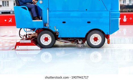 A Stadium Worker Cleans An Ice Rink On A Blue Modern Ice Cleaning Machine, Copy Space.