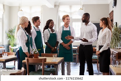 Staff Attending Team Meeting In Empty Dining Room - Shutterstock ID 1176110662