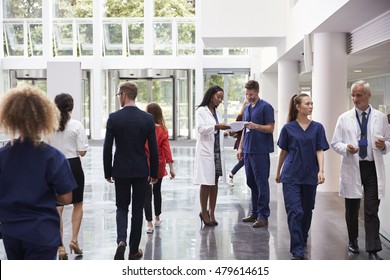 Staff In Busy Lobby Area Of Modern Hospital