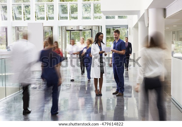Staff In Busy Lobby\
Area Of Modern Hospital