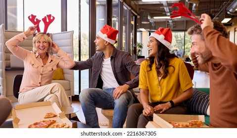 Staff Celebrating With Christmas Party And Meal In Office - Powered by Shutterstock