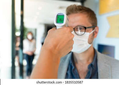 Staff Check Fever By Digital Thermometer Visitor Before Entering The Airport For Scan And Protect From Coronavirus