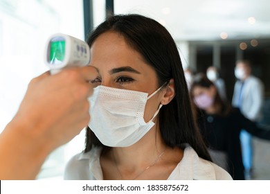 Staff Check Fever By Digital Thermometer Visitor Before Entering The Airport For Scan And Protect From Coronavirus