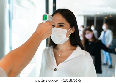 Staff Check Fever By Digital Thermometer Visitor Before Entering The Airport For Scan And Protect From Coronavirus