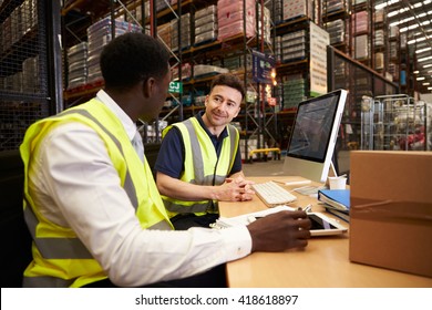 Staff Discuss Warehouse Logistics In An On-site Office