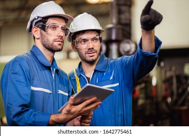 Staff Engineers In Uniforms And Safety Helmet Are Inspecting Work And The Job Training He Works In Factory Industrial Machinery.