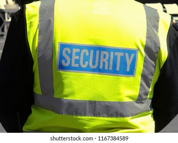 Staff Member With Security Written On Back Of Jacket